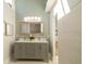 Bathroom with double sink vanity, decorative mirror, and a view of the tiled shower at 1510 49Th N St, St Petersburg, FL 33710