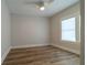 This bedroom features a neutral color scheme, complemented by wood flooring and a bright window at 1510 49Th N St, St Petersburg, FL 33710