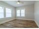Bright bedroom with wood floors, complemented by two light filled windows and a contemporary ceiling fan at 1510 49Th N St, St Petersburg, FL 33710