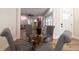 Dining room features a glass table, gray upholstered chairs, and a seamless transition to living area at 1510 49Th N St, St Petersburg, FL 33710