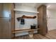Stylish entryway featuring custom cabinets, bench with pillows, and a unique wood accent coat rack at 1510 49Th N St, St Petersburg, FL 33710