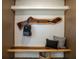 Custom entryway design with a live edge bench, coat rack, storage cabinets and luxury flooring at 1510 49Th N St, St Petersburg, FL 33710