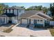 Charming blue craftsman style home featuring a brick driveway, attached garage, and manicured landscaping at 1510 49Th N St, St Petersburg, FL 33710
