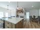 Open kitchen featuring an island with seating, pendant lights, and open shelving for decor at 1510 49Th N St, St Petersburg, FL 33710