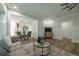 Open-concept living area with white walls, wood-look floors, a modern sofa and paneled walls at 1510 49Th N St, St Petersburg, FL 33710