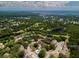 Gorgeous aerial view of the community with lake, green space, and nearby ocean at 1701 Brigadoon Dr, Clearwater, FL 33759