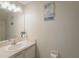 Bathroom featuring bright mirror, fresh vanity, and decorative beach themed wall art at 1701 Brigadoon Dr, Clearwater, FL 33759