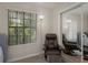 Bedroom with large window, comfortable chair and mirorred sliding closet at 1701 Brigadoon Dr, Clearwater, FL 33759