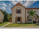 Charming townhouse with two stories, neutral paint, and decorative shutters at 1701 Brigadoon Dr, Clearwater, FL 33759