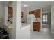 Compact kitchen features wood cabinets and a white refrigerator at 1701 Brigadoon Dr, Clearwater, FL 33759