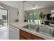 Open kitchen with stainless steel sink overlooking the backyard at 1701 Brigadoon Dr, Clearwater, FL 33759