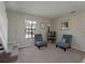 Bright living room with two chairs and a window offering natural light and cozy charm at 1701 Brigadoon Dr, Clearwater, FL 33759