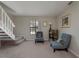 Inviting living room featuring a staircase, soft natural light and cozy seating area at 1701 Brigadoon Dr, Clearwater, FL 33759