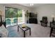 Living room with sliding glass doors, carpet flooring and ceiling fan at 1701 Brigadoon Dr, Clearwater, FL 33759