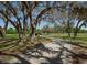 Nice view of the park, complete with walking trail, bridge, and grand shady trees at 1701 Brigadoon Dr, Clearwater, FL 33759