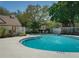 Cool off in the community pool with lounge chairs and lush greenery surrounding the pool at 1701 Brigadoon Dr, Clearwater, FL 33759