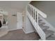 Bright stairway featuring plush carpeted steps and a white railing leading to the upper level at 1701 Brigadoon Dr, Clearwater, FL 33759