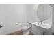 Half bath with pedestal sink, round mirror, and tile flooring at 1895 Ridgemore St, North Port, FL 34289