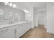Elegant bathroom with double vanity, modern lighting, and wood-look tile flooring at 1895 Ridgemore St, North Port, FL 34289