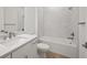Bathroom featuring double sinks, tub and shower with tile surround at 1895 Ridgemore St, North Port, FL 34289