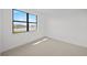 Well-lit bedroom with plush carpet and a large window overlooking a pond at 1895 Ridgemore St, North Port, FL 34289