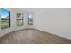 Corner bedroom with tile floors and large windows offering ample natural light and views at 1895 Ridgemore St, North Port, FL 34289