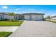 Charming single-Gathering home features a paved driveway, a two-car garage, and landscaped front yard at 1895 Ridgemore St, North Port, FL 34289