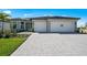Beautiful single-story home with a paved driveway, two-car garage, and well-maintained landscaping at 1895 Ridgemore St, North Port, FL 34289