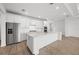 Elegant kitchen with white cabinets, a center island, and stainless steel appliances at 1895 Ridgemore St, North Port, FL 34289