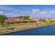 Aerial view of waterfront condos showcasing red tile roofs, lush landscaping and private waterfront access at 19029 Us Highway 19 N # 21E, Clearwater, FL 33764