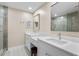 Bright bathroom featuring double sinks with quartz countertops, sleek fixtures, and a large, modern vanity at 19029 Us Highway 19 N # 21E, Clearwater, FL 33764