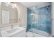 Beautiful bathroom featuring a blue tiled shower, sink, and toilet at 19029 Us Highway 19 N # 21E, Clearwater, FL 33764
