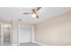 Cozy bedroom with wood-look flooring, ceiling fan, and closet space at 19029 Us Highway 19 N # 21E, Clearwater, FL 33764