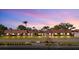 Waterfront condo complex featuring red tile roofs, well-manicured landscaping, and lovely sunset views at 19029 Us Highway 19 N # 21E, Clearwater, FL 33764