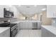 Modern kitchen with stainless steel appliances, white cabinetry, and quartz countertops at 19029 Us Highway 19 N # 21E, Clearwater, FL 33764