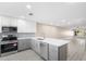 Updated kitchen with white cabinets, quartz countertops, and stainless steel appliances at 19029 Us Highway 19 N # 21E, Clearwater, FL 33764
