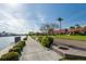 A waterfront walkway with manicured landscaping and views of the water and condos at 19029 Us Highway 19 N # 21E, Clearwater, FL 33764