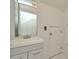 Bathroom featuring a vanity with storage, framed mirror, and white tile floors at 2263 Fluorshire Dr, Brandon, FL 33511