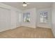This bedroom features neutral walls, carpet, two windows, and a double door closet at 2263 Fluorshire Dr, Brandon, FL 33511