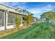 Exterior view of the back of the home, showcasing a screened patio and green lawn at 2263 Fluorshire Dr, Brandon, FL 33511