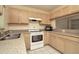 Bright kitchen features light wood cabinets and white appliances at 2263 Fluorshire Dr, Brandon, FL 33511