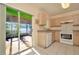 Bright kitchen features a sliding glass door and white appliances at 2263 Fluorshire Dr, Brandon, FL 33511