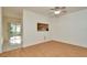 Living room with light wood flooring, ceiling fan and window into the kitchen at 2263 Fluorshire Dr, Brandon, FL 33511