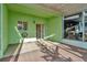 A screened patio with green walls, a ceiling, and a sliding glass door at 2263 Fluorshire Dr, Brandon, FL 33511