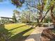 An expansive backyard showcasing a well-manicured lawn and a private dock for boating and waterfront enjoyment at 2632 S Dundee St, Tampa, FL 33629