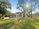 Expansive backyard view showcasing lush green lawn, private pool, and an elegant home exterior at 2632 S Dundee St, Tampa, FL 33629