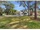 Expansive backyard showcasing a luxurious pool and verdant lawn, perfect for outdoor relaxation and activities at 2632 S Dundee St, Tampa, FL 33629