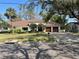 Beautiful home with a well-manicured lawn, mature trees, and a two-car garage at 2632 S Dundee St, Tampa, FL 33629