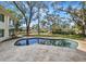 Backyard pool with large patio and backyard for entertaining or enjoying nature at 2632 S Dundee St, Tampa, FL 33629