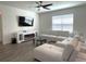 Relaxing living room showcasing a modern fireplace, TV, and comfortable white sectional couch at 31888 Treasure Dock Isle, Wesley Chapel, FL 33545